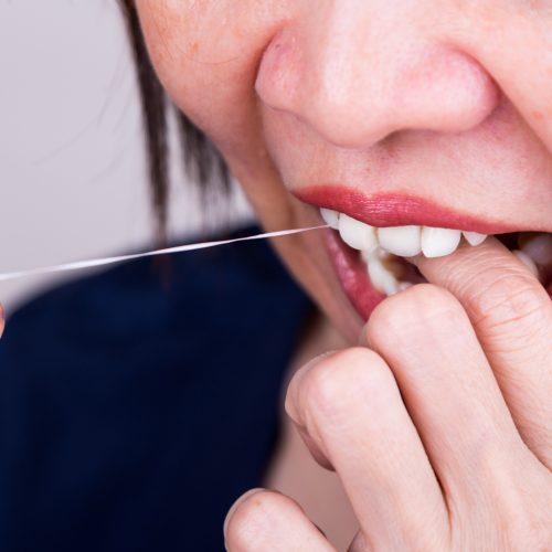 Flossing Teeth helps for good dental hygiene